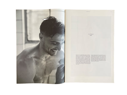Black and white photo of a shirtless Lucas Krzikalla with text on a magazine page.